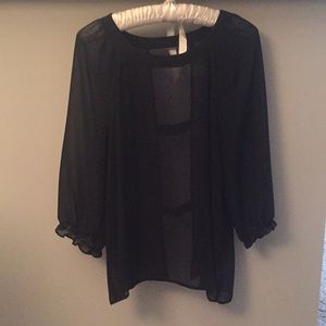 Sheer black top. Open in the back.